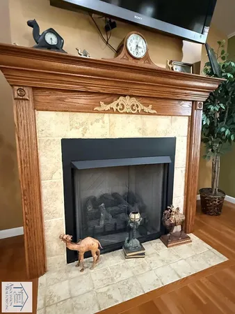 a view of living room with furniture and a fireplace