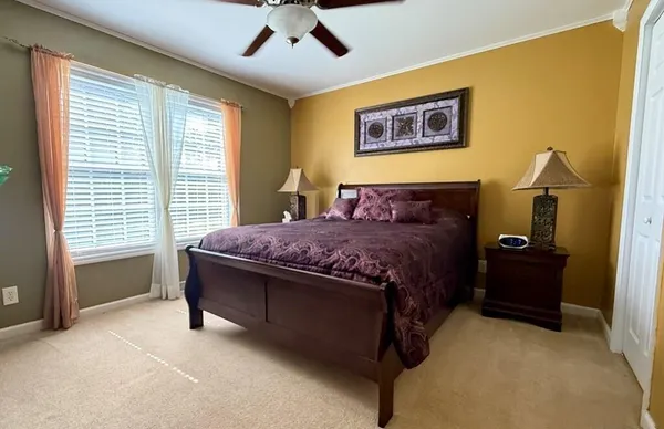a bedroom with a bed and a large window