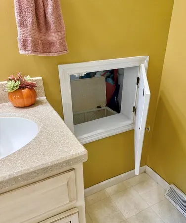 a utility room with a sink and washing machine