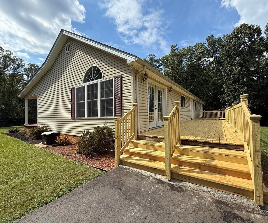 100 Flamingo Road Bassett, VA 24055 - Photo 27 of 30 a view of backyard of house with outdoor seating and trees in the background