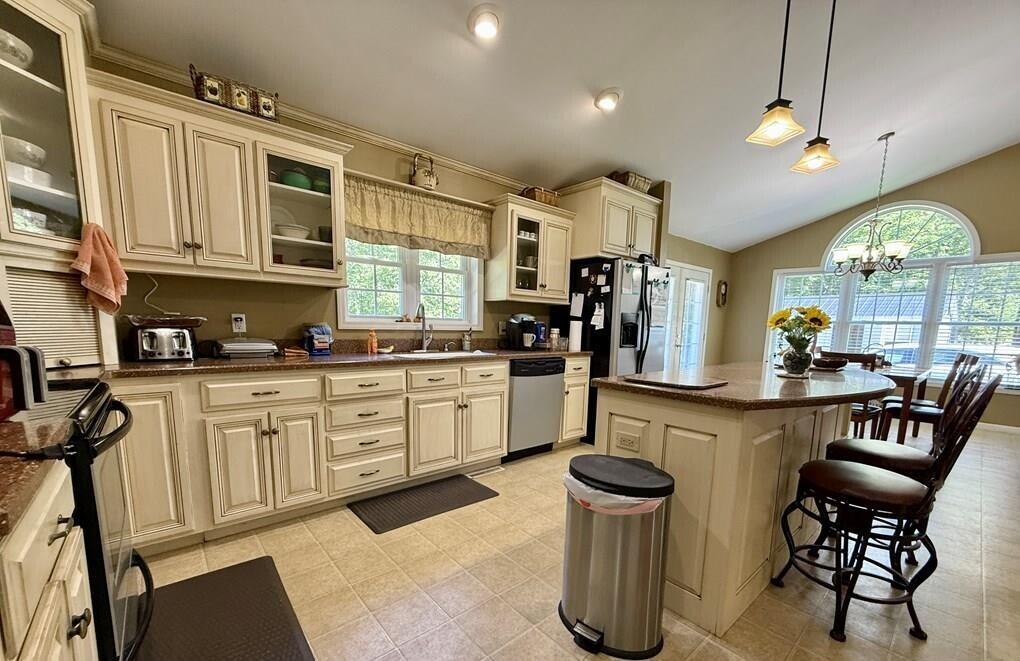 100 Flamingo Road Bassett, VA 24055 - Photo 6 of 30 a kitchen with a sink cabinets and dining table chair