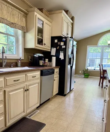 a kitchen with cabinets and window