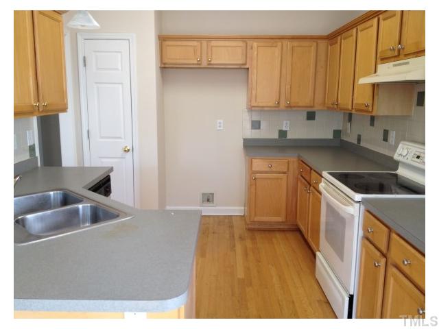 8700 Neuse Village Court Raleigh, NC 27616 - Photo 4 of 11 a kitchen with a sink and cabinets