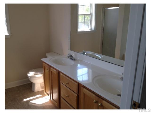 8700 Neuse Village Court Raleigh, NC 27616 - Photo 7 of 11 a bathroom with a toilet sink and mirror