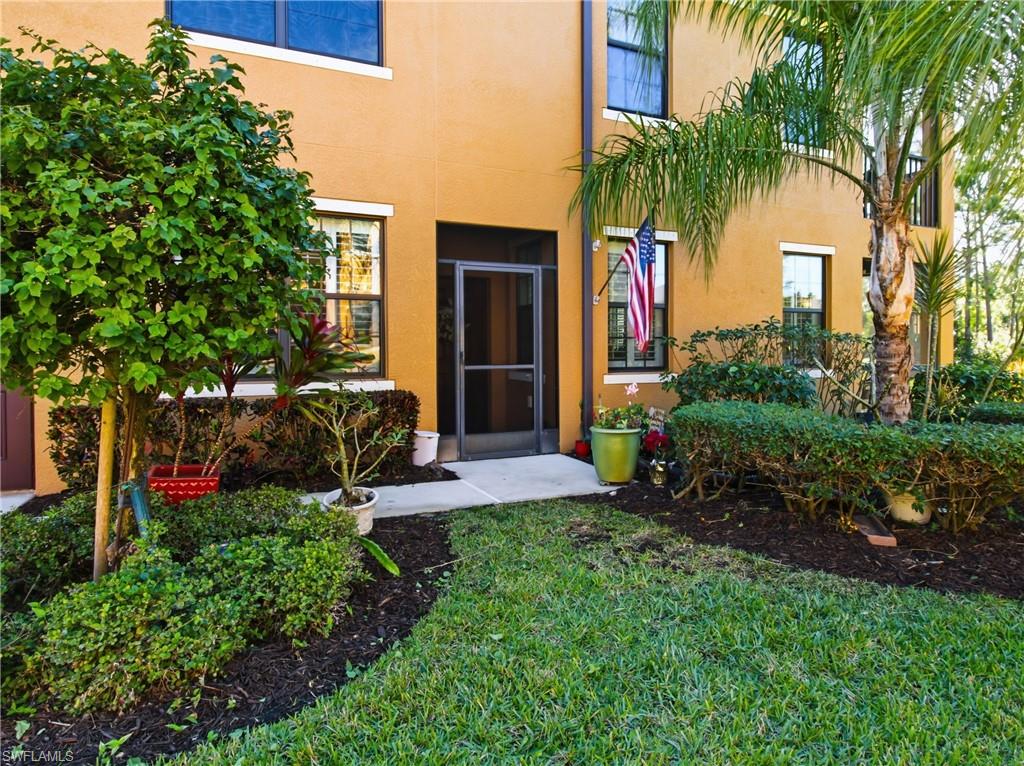 20161 Bravada Street, Unit 2 Estero, FL 33928 - Photo 4 of 33 a view of a house with a yard and potted plants