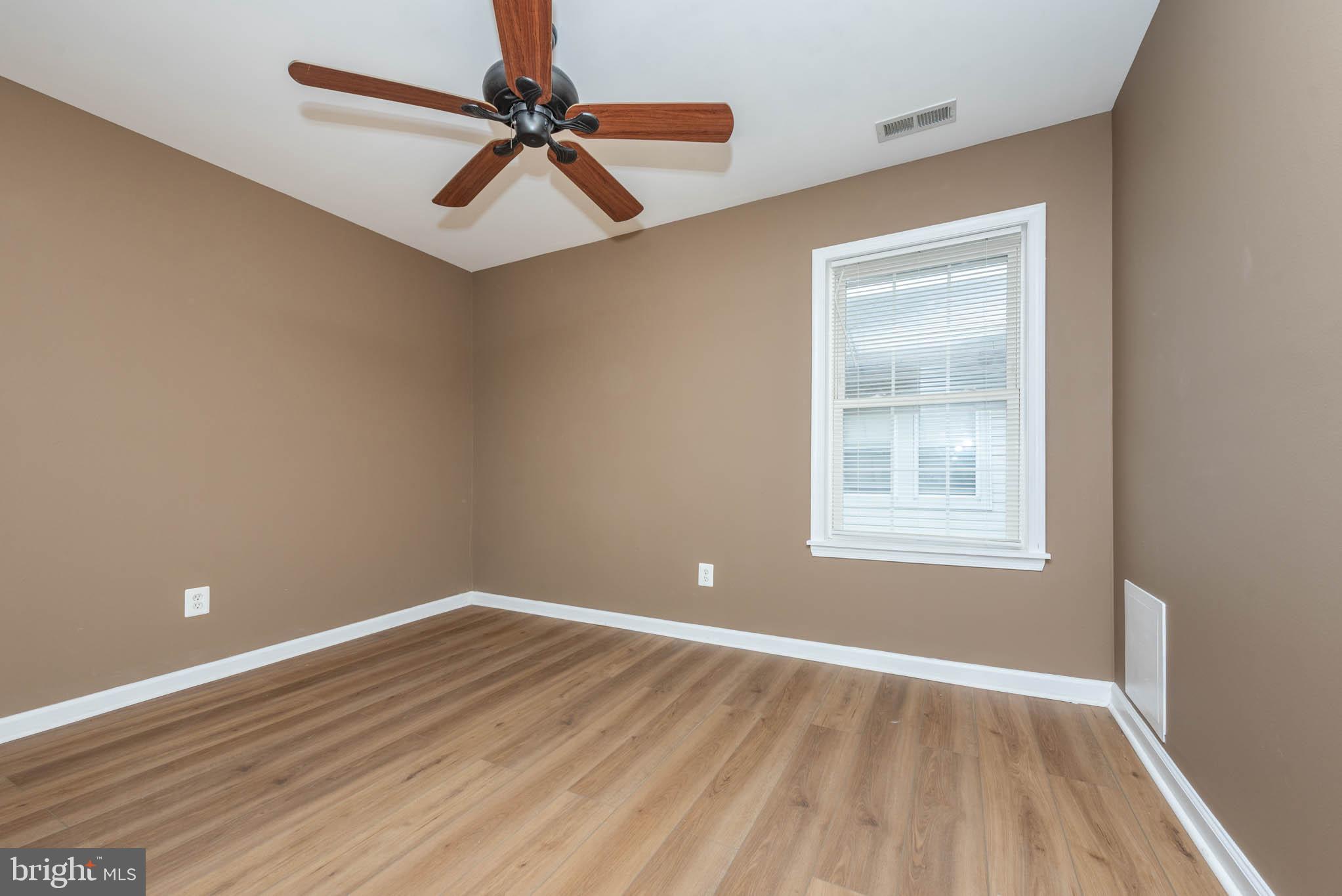 4021 Barrington Road Baltimore, MD 21207 - Photo 22 of 50 wooden floor in an empty room with a window