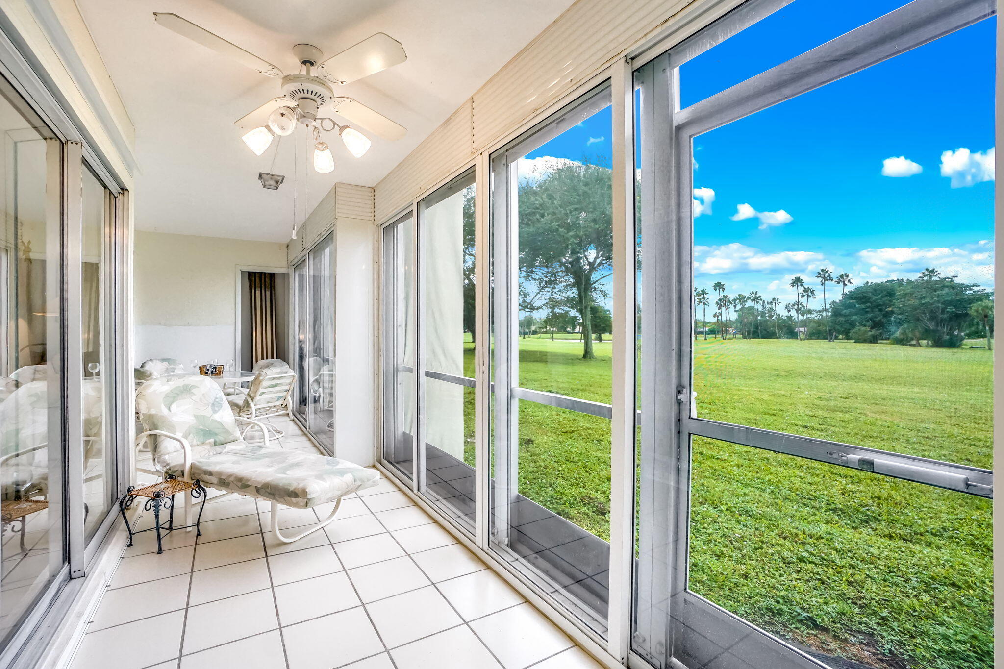 3951 Via Poinciana, Unit 114 Lake Worth, FL 33467 - Photo 12 of 34 a living room with patio furniture and garden view