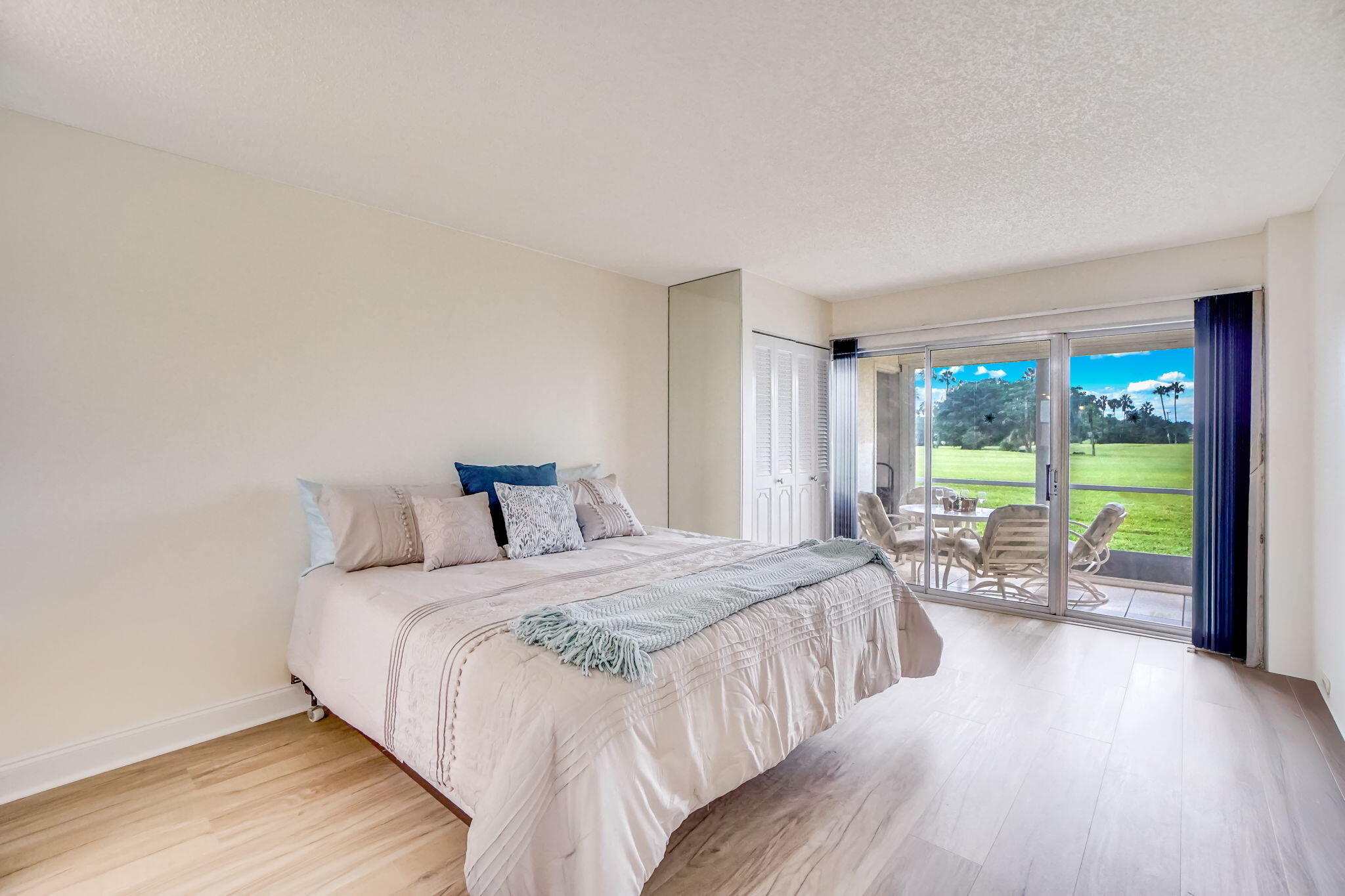 3951 Via Poinciana, Unit 114 Lake Worth, FL 33467 - Photo 14 of 34 a bedroom with a bed and a large window