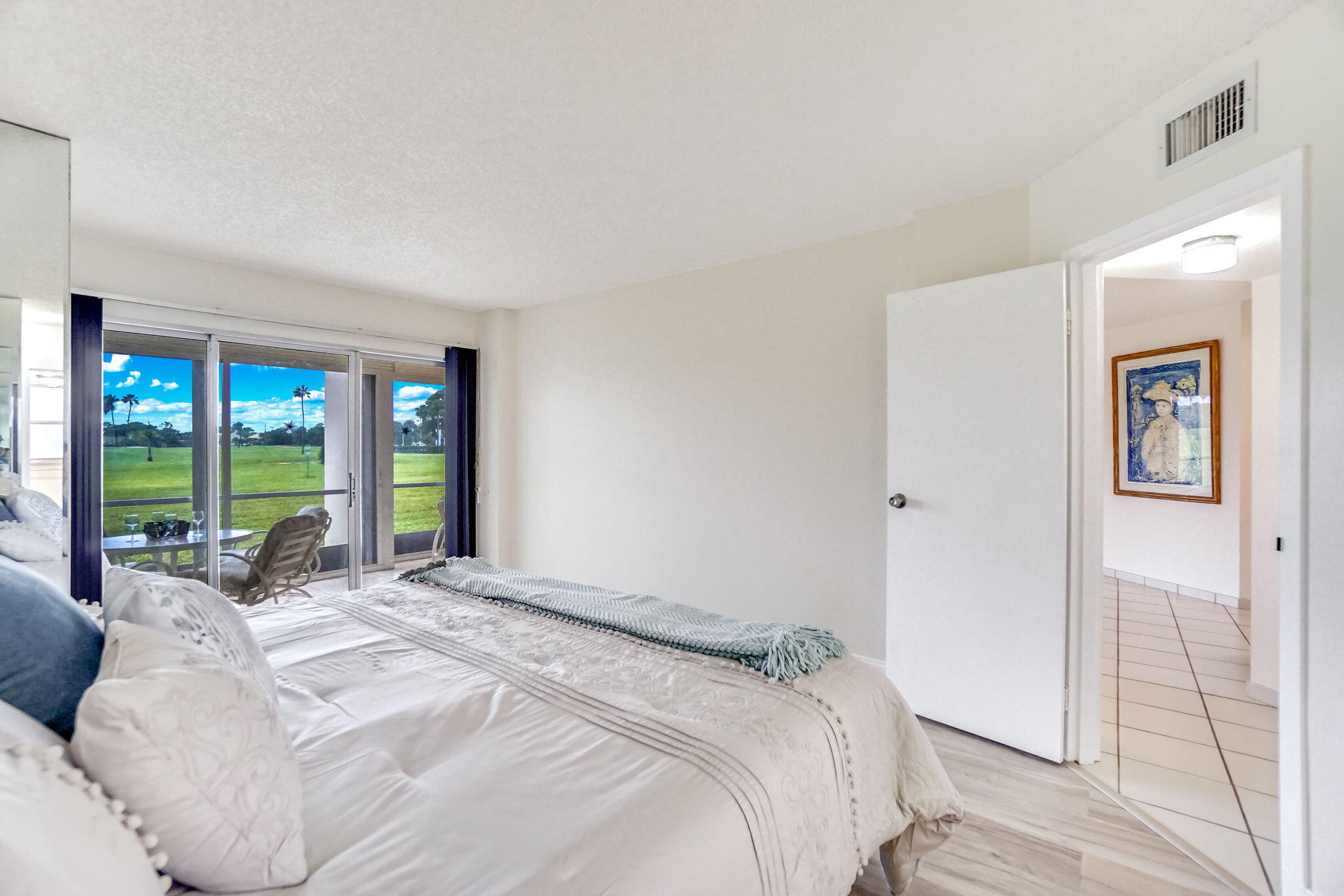 3951 Via Poinciana, Unit 114 Lake Worth, FL 33467 - Photo 15 of 34 a bed sitting in a spacious bedroom next to a window