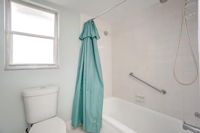 a bathroom with a toilet and a bathtub