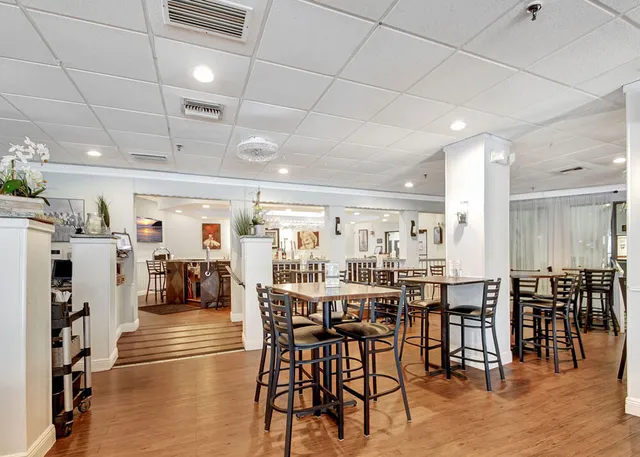 a small pool that has lawn chairs in front of it