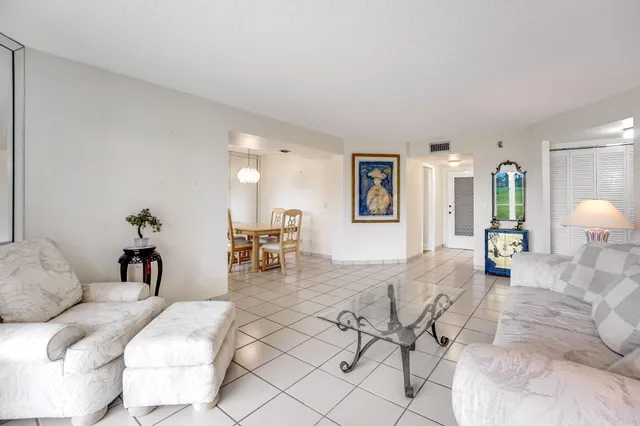 a living room with furniture and a lamp