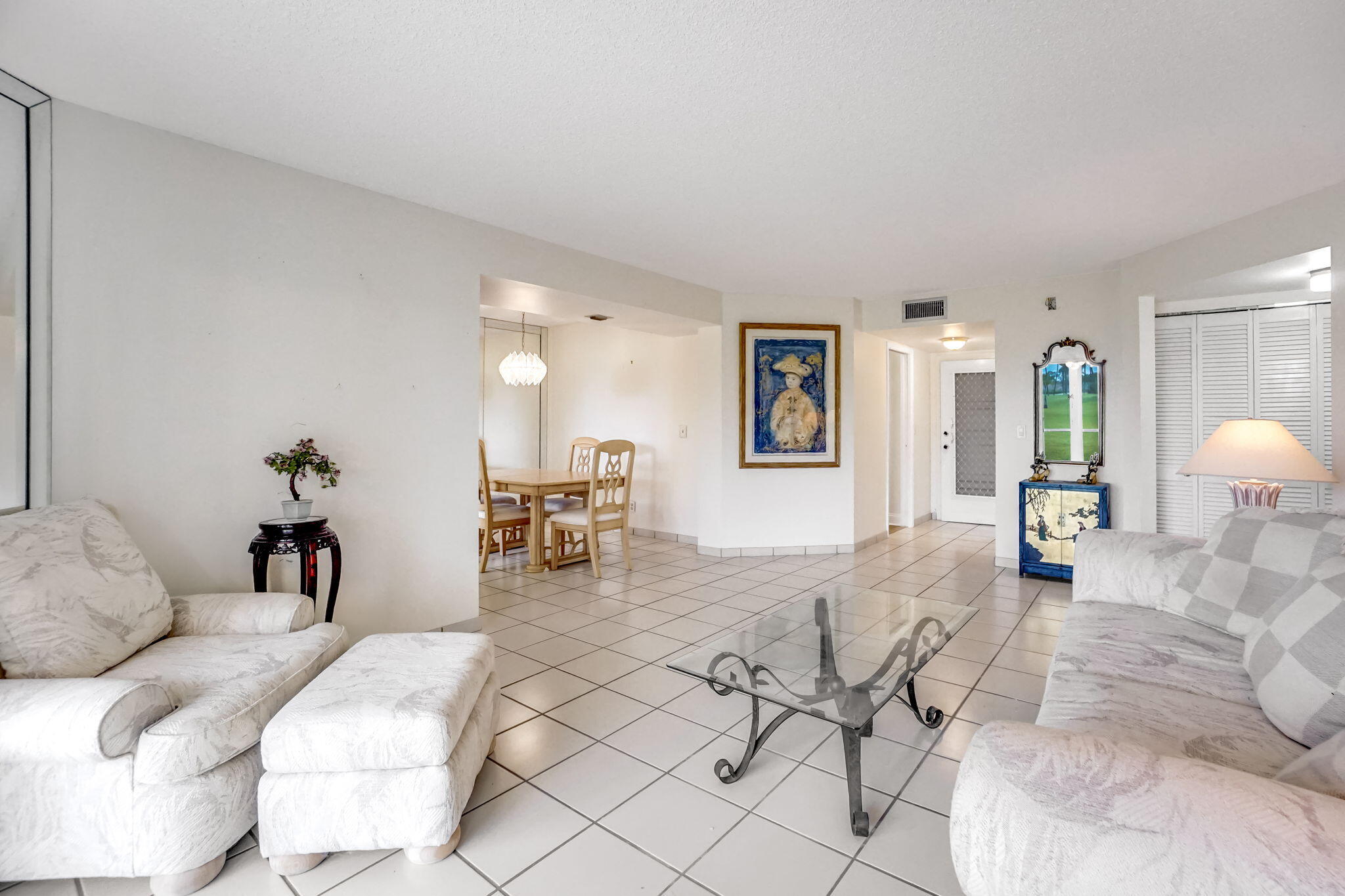 3951 Via Poinciana, Unit 114 Lake Worth, FL 33467 - Photo 5 of 34 a living room with furniture and a lamp