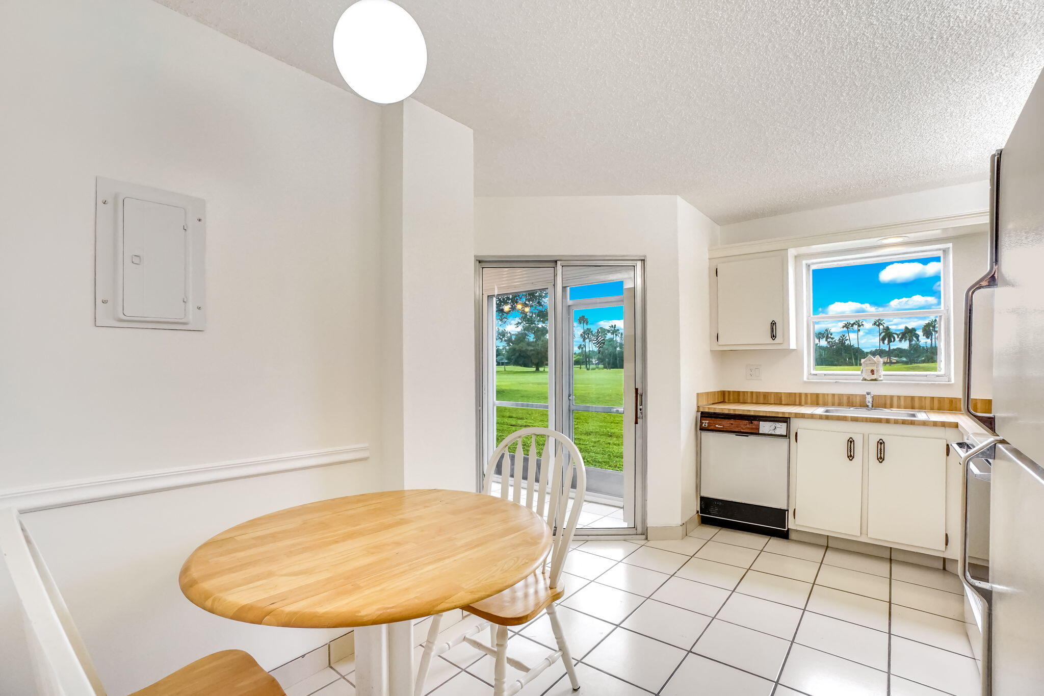 3951 Via Poinciana, Unit 114 Lake Worth, FL 33467 - Photo 10 of 34 a kitchen with a table chairs and a stove