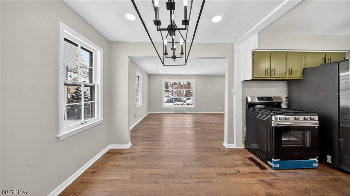 16811 Invermere Avenue Cleveland, OH 44128 - Photo 13 of 47 Kitchen featuring appliances with stainless steel finishes, dark wood-style floors, recessed lighting, decorative light fixtures, and a chandelier