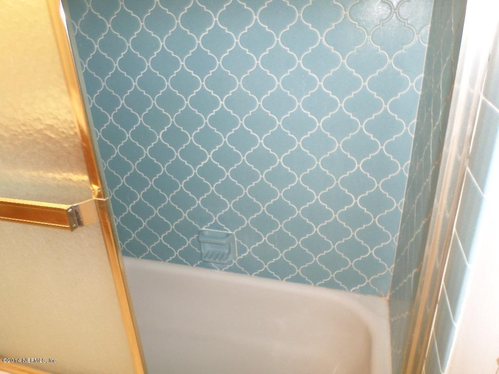 11685 Mandarin Road Jacksonville, FL 32223 - Photo 8 of 21 a bathroom with a shower curtain