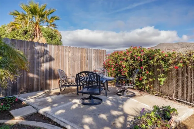 a view of a porch with furniture and a yard