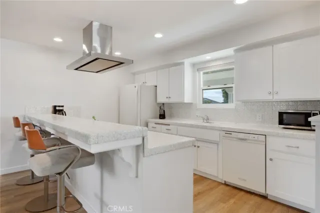 a kitchen with stainless steel appliances cabinets a sink and a refrigerator
