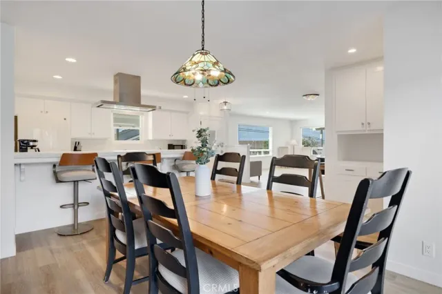 a view of a dining room with furniture and chandelier