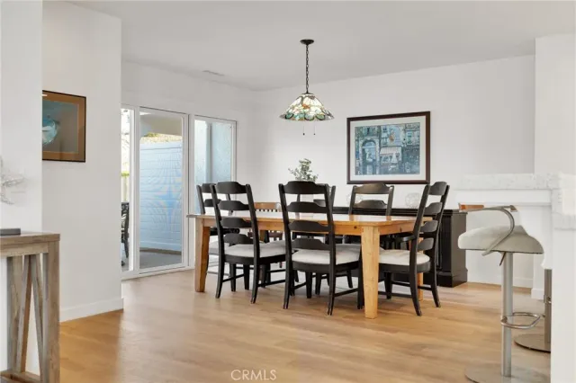 a view of a dining room with furniture wooden floor and chandelier