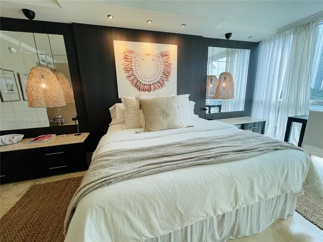 a bedroom with a bed and a mirror