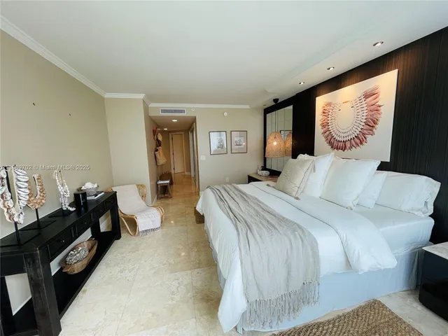 a bedroom with a bed and dresser with mirror