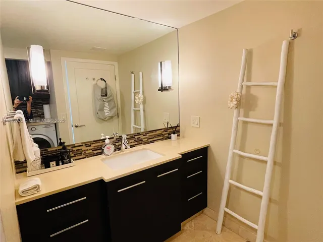a bathroom with a double vanity sink a and mirror