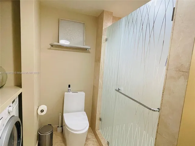 a white toilet sitting next to a small bathroom