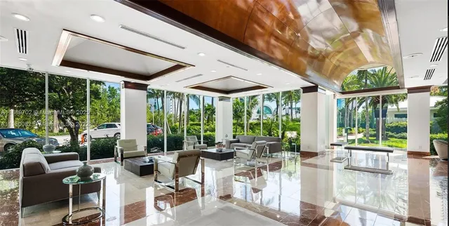 a view of a patio with table and chairs under an umbrella with large trees
