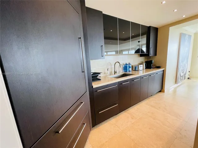 a kitchen with cabinets and wooden floor