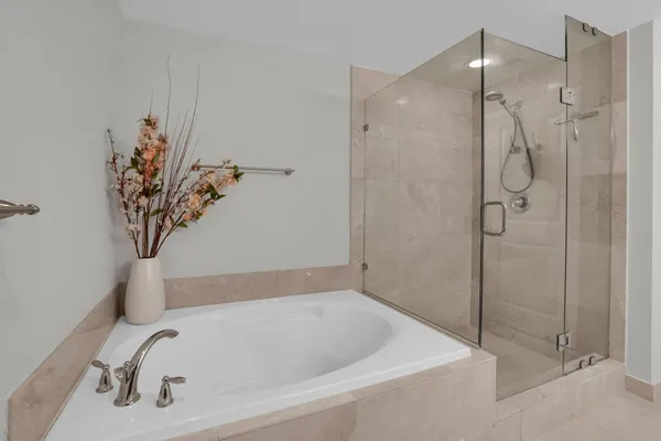 a bathroom with a tub and shower