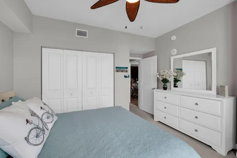 a dining room with wooden floor a chandelier fan a wooden table and chairs