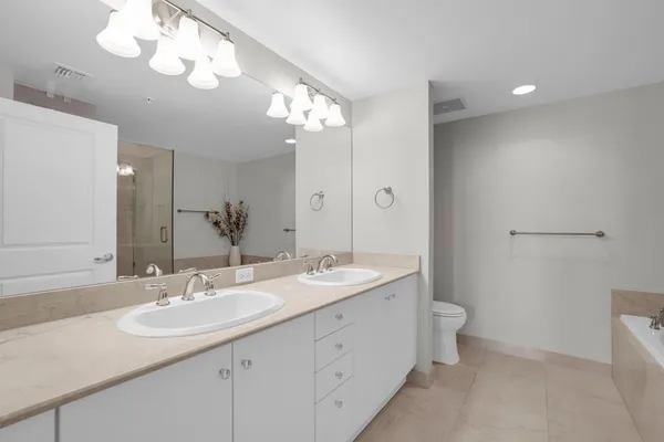 a bathroom with a sink a toilet and a mirror