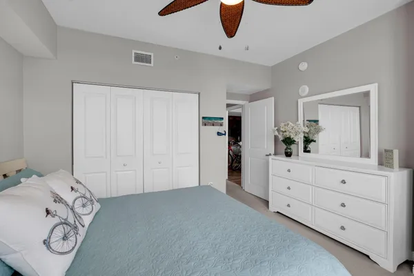 a view of a bedroom with furniture and closet