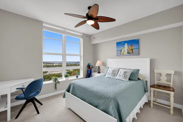 a bedroom with a bed and a large window