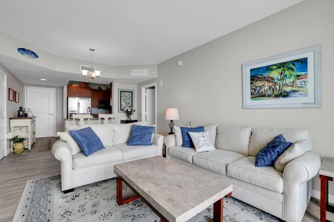 a bedroom with a large bed and a flat tv screen on dresser