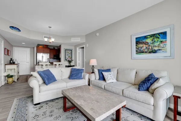 a living room with furniture and kitchen view