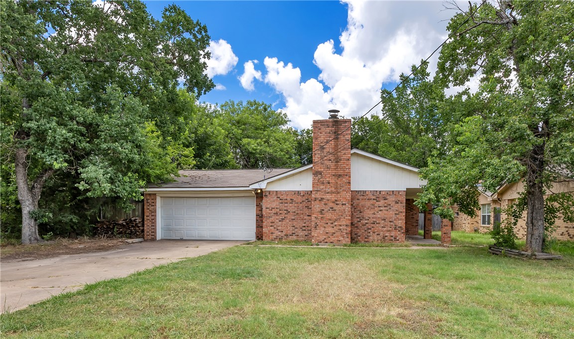Single-story residence featuring brick exterior detailing and a prominent brick chimney
