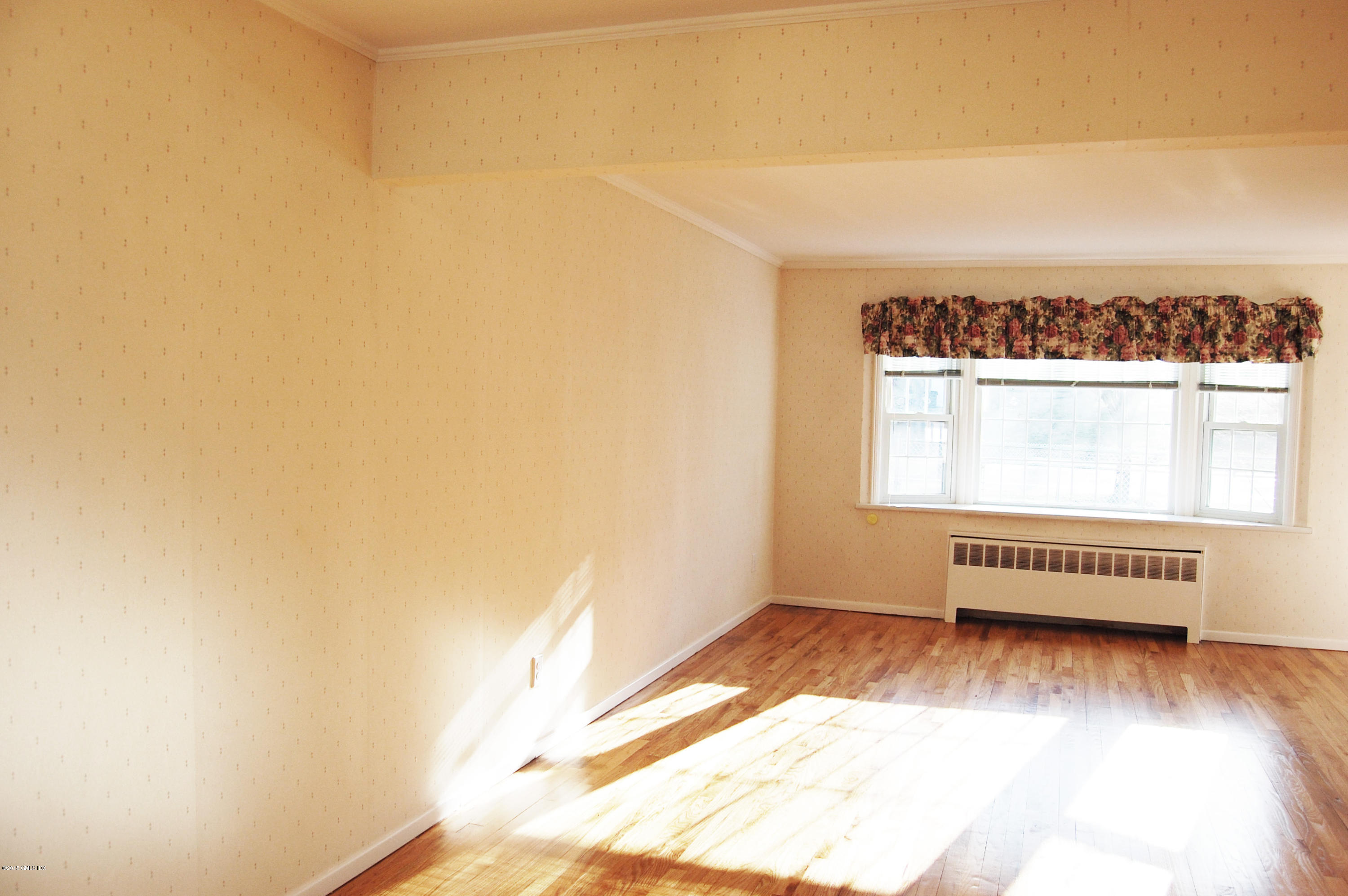 55 Sound Beach Ave Extension Riverside, CT 06878 - Photo 4 of 9 a view of a room with wooden floor and a window