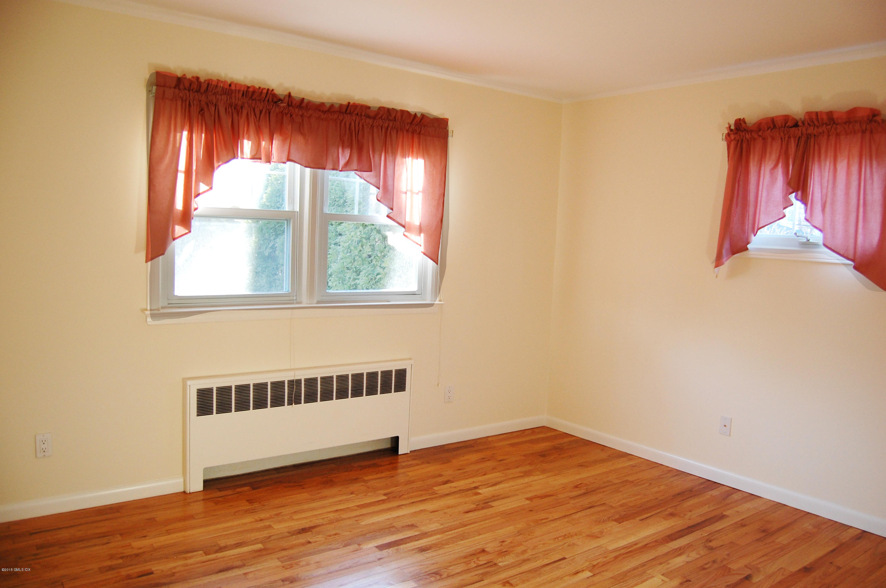 55 Sound Beach Ave Extension Riverside, CT 06878 - Photo 5 of 9 a view of a room with wooden floor and windows