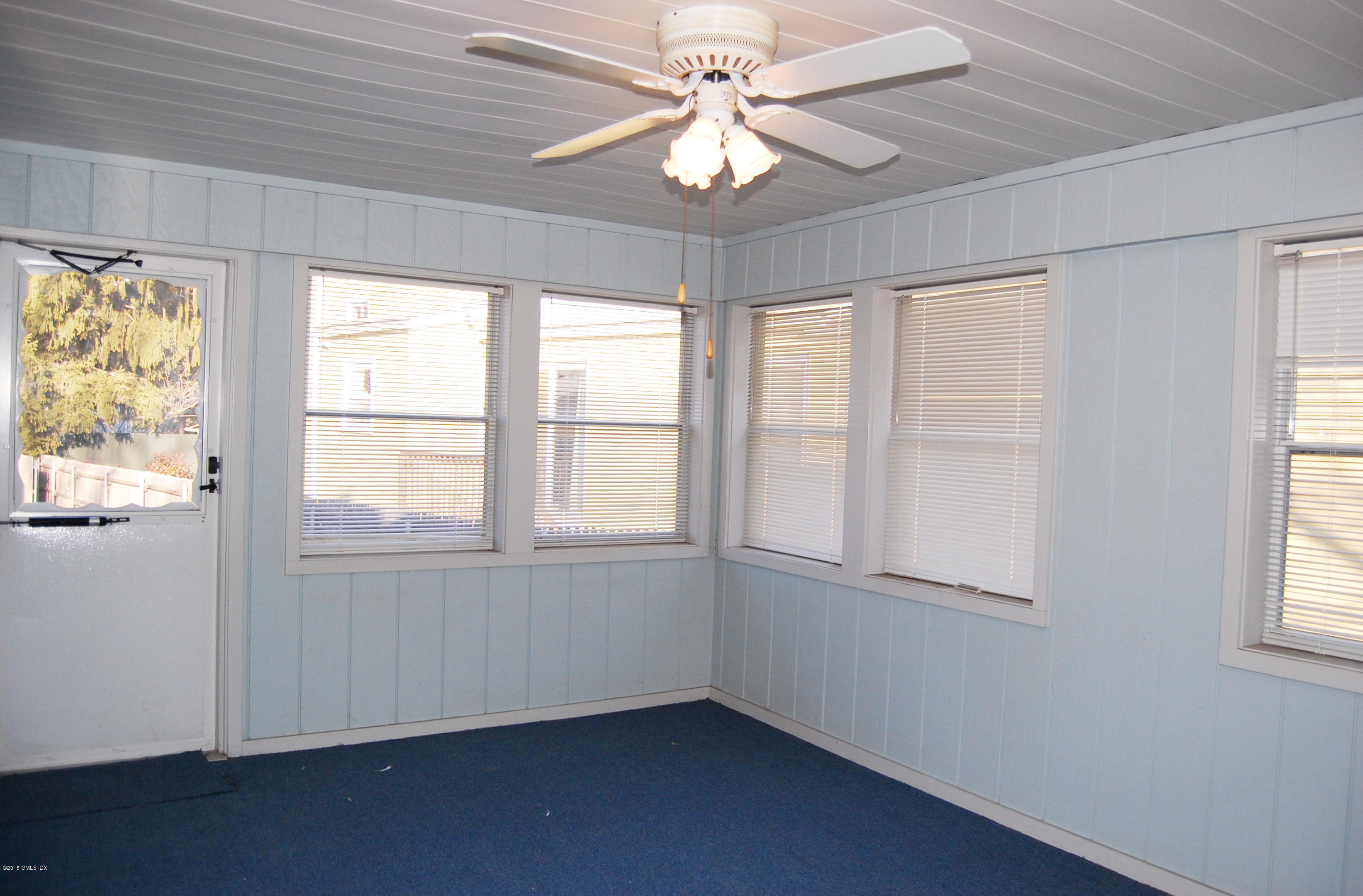 55 Sound Beach Ave Extension Riverside, CT 06878 - Photo 8 of 9 an empty room with chandelier fan and windows