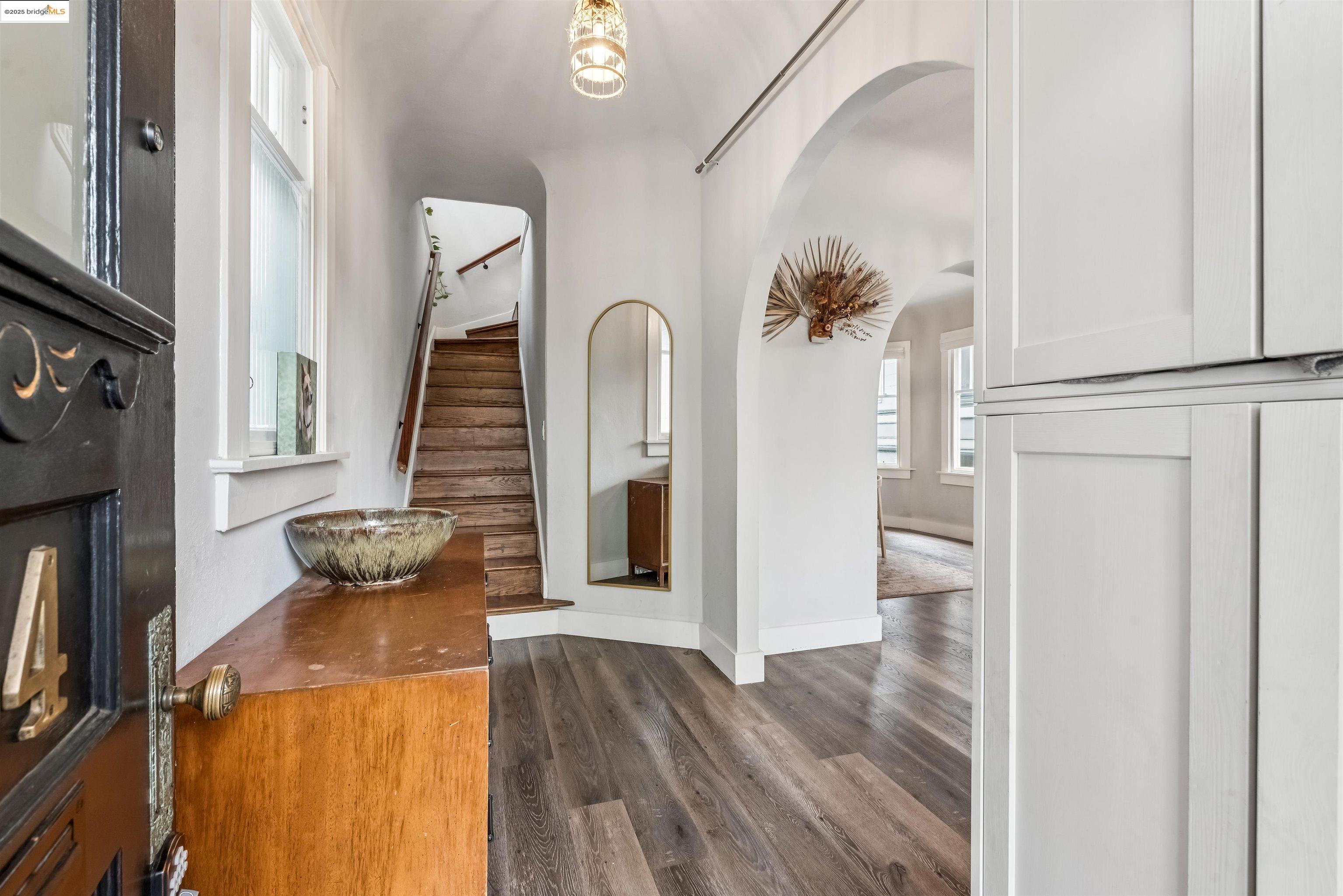 1254 Broadway Alameda, CA 94501 - Photo 2 of 12 Entryway featuring stairs, dark wood-style flooring, and arched walkways