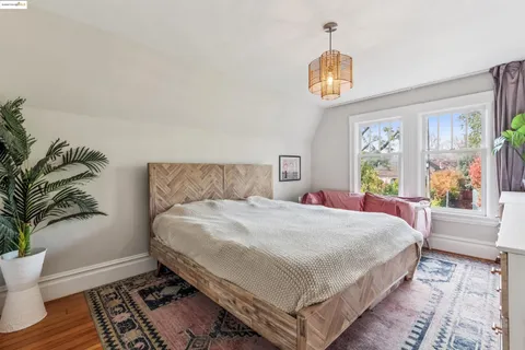 a bedroom with a large bed and a window