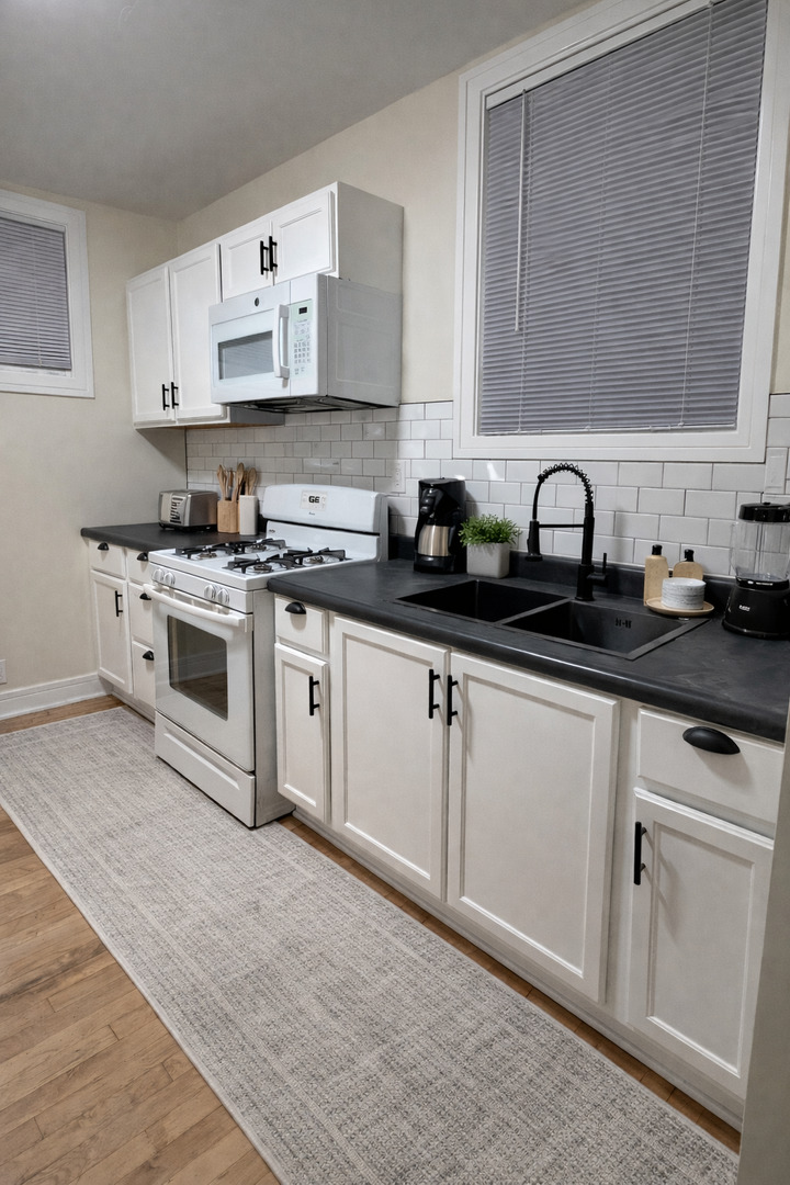 610 East 74th Street, Unit 2B Chicago, IL 60619 - Photo 5 of 7 a white kitchen with sink and cabinets