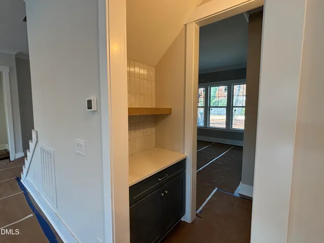 a en suite bathroom with a granite countertop sink and a mirror