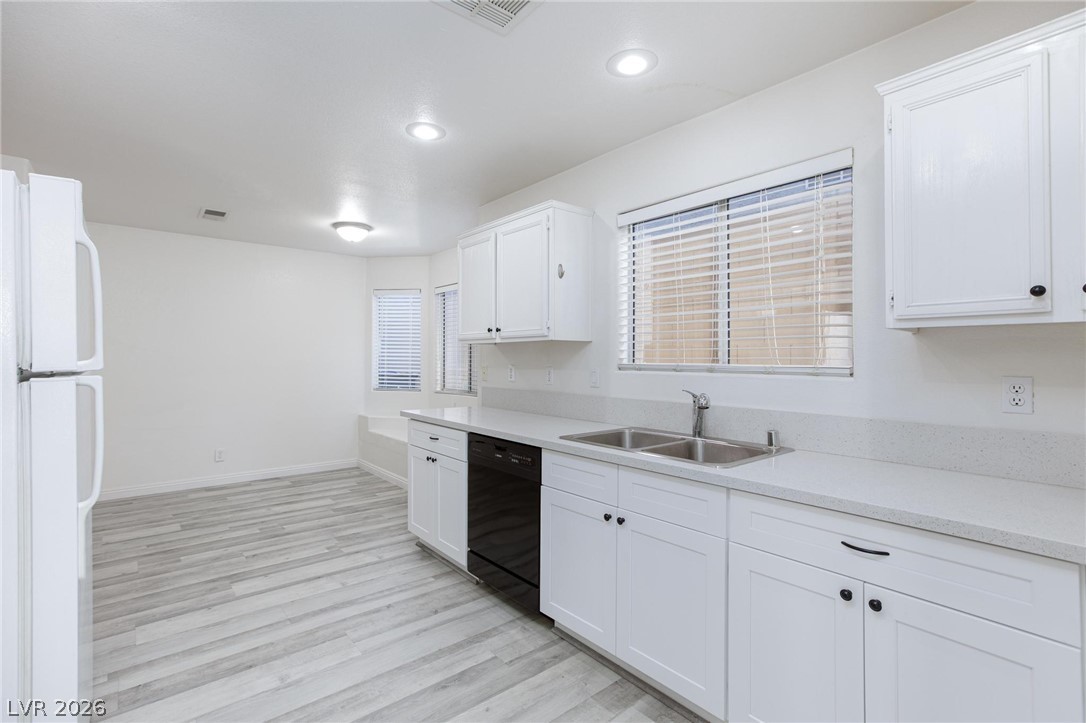 2246 Ramsgate Drive Henderson, NV 89074 - Photo 9 of 36 Bright, refreshed kitchen features pristine white cabinetry and modern flooring.