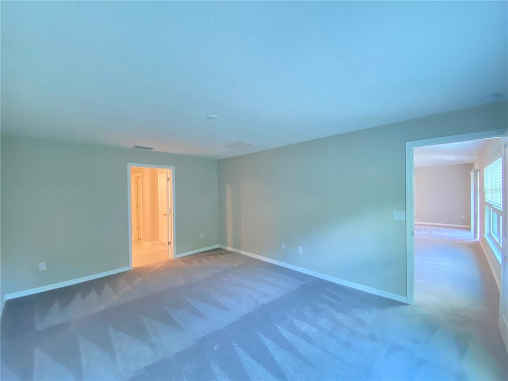 2530 Southwest 167th Loop Ocala, FL 34473 - Photo 13 of 31 an empty room with a window and wooden floor