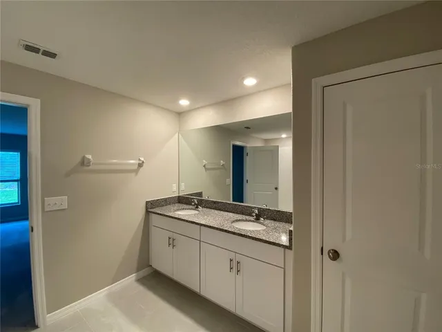 a bathroom with a shower and a glass door