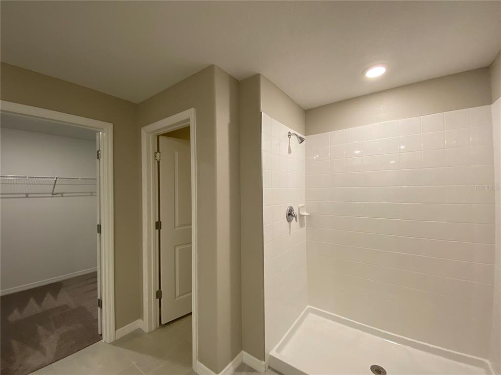 2530 Southwest 167th Loop Ocala, FL 34473 - Photo 16 of 31 a bathroom with a shower and a glass door