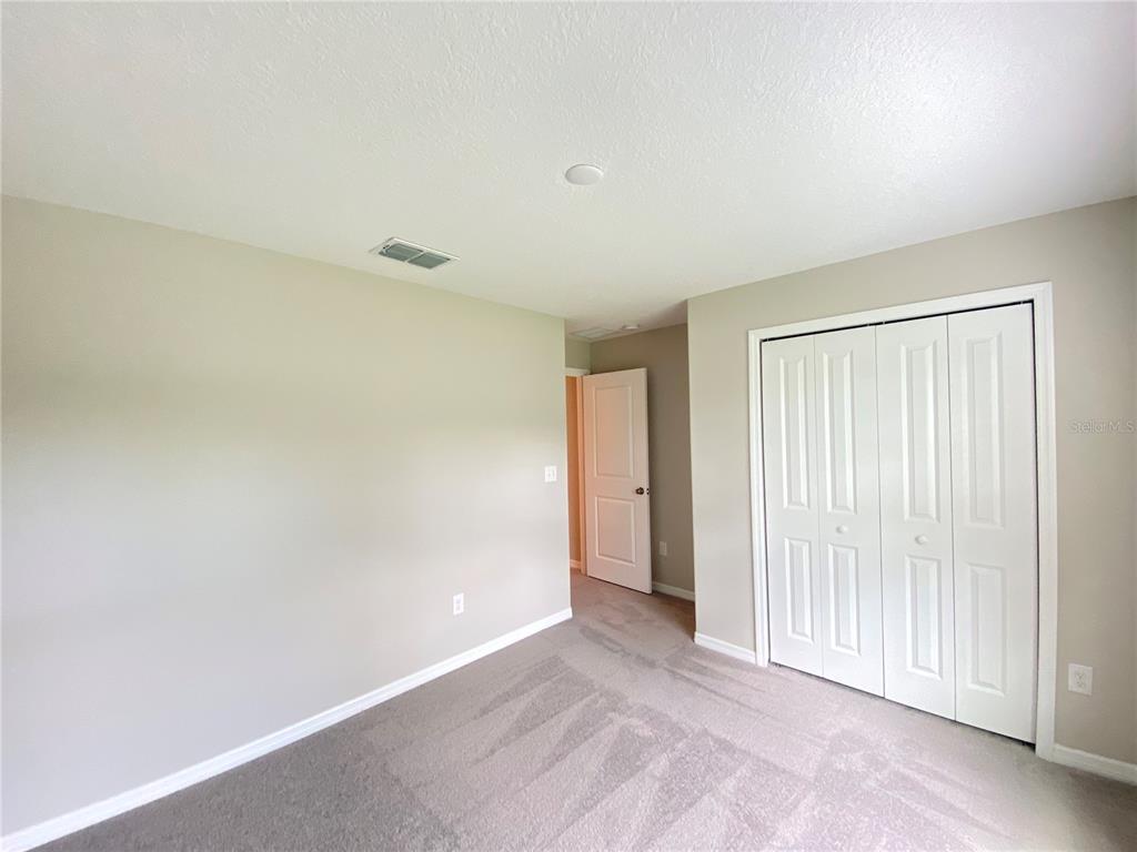 2530 Southwest 167th Loop Ocala, FL 34473 - Photo 17 of 31 an empty room with sliding door